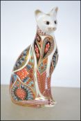 A Royal Crown Derby paperweight in the form of a cat having original gold crown stopper. Measures