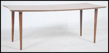 A vintage retro 20th century veneered teak wood effect coffee table having a shaped panel top raised