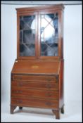 An Edwardian mahogany matched inlaid bureau bookcase having astragal glazed doors over bureau to the