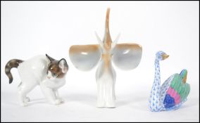 A Rosethall German ceramic cat along with a Hollohaza Hungarian Elephant figurine and a Herend