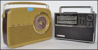 A vintage mid century Bush All Multiband portable radio with push button and dial facia together