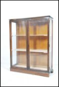 A vintage 20th century  oak china display cabinet having a pair of glazed doors with a series of