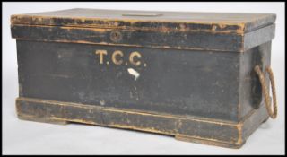 A VIctorian ebonised pine tool chest - steamer trunk having monogram front with hinged top having