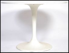 A contemporary Arkana style tulip table being raised on weighted plastic tulip base with a