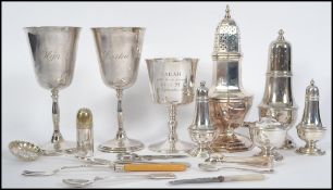 A collection of vintage 20th century silver plated items to include sugar shakers, cruets together