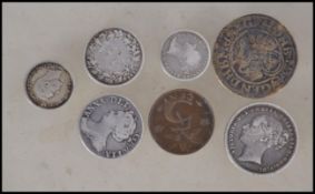A collection of coins to include a Queen Anne Silver Sixpence 1711, a 16th century Nuremburg Jeton