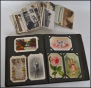 An interesting early 20th century Edwardian postcard album containing humorous, artist drawn, and