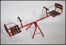 A vintage mid century tubular metal childs seesaw