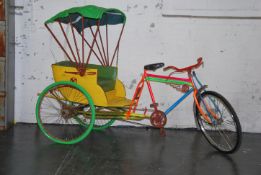 A vintage asian full size rickshaw bicycle having