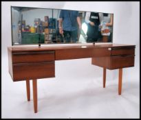 A 1970's retro teak wood dressing table having ped