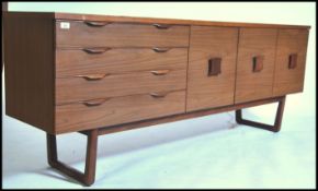 A 1970's Danish sideboard style teak raised on ang