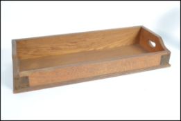 A Victorian oak library tray with bracket work joi
