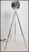 An Andrew Martin polished steel tripod lamp. The l
