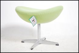 After Arne Jacobsen. A polished steel and green fa