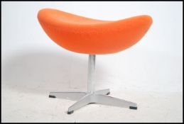 After Arne Jacobsen. A polished steel and orange f