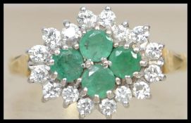 An 18ct gold, diamond and emerald ladies cluster r