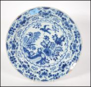 An 18th century delft bowl charger in blue and whi