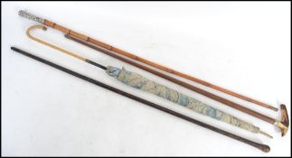 A collection of walking sticks / canes to include