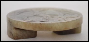 An Oriental jade belt buckle depicting peaches and