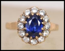 A hallmarked 9ct gold and sapphire ring being set
