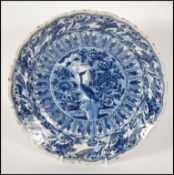 An 18th century delft charger bowl in blue and whi