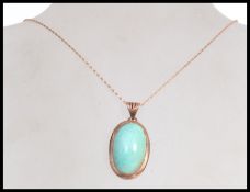 A stunning 9ct gold and turquoise set pendant and