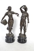 A pair of hollow cast bronze figures, each being r
