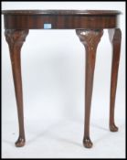 An antiques style mahogany demi lune console table