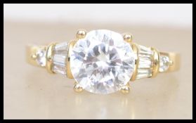 A hallmarked 9ct gold ring set with a large centra