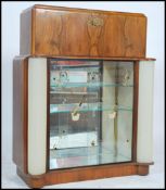 A 1950's post war Art Deco cocktail cabinet having