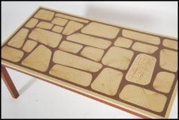 A 1970's retro teak wood and faux formica tile top