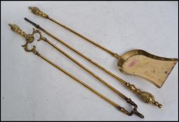 An early 20th century 3 piece brass companion set