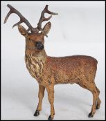 A cold painted 19th century figurine of a stag hav