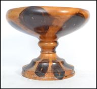 A 1930's palm wood tazza raised on a terraced foor