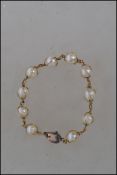 A vintage 18 carat gold pearl bracelet chain havin