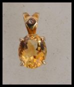 A hallmarked 9ct gold pendant set with a faceted c