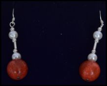 An African Tribal style silver and apple coral sui