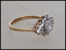 A hallmarked 9ct gold and CZ cluster ring . Hallma