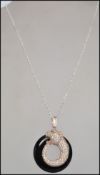 A contemporary silver and onyx panther pendant nec
