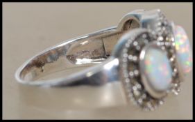 A silver ladies Art Deco style 3 stone opal ring.