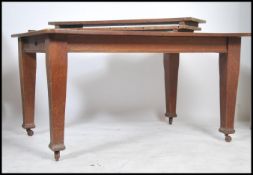 An Edwardian Arts & Crafts solid oak twin leaf win