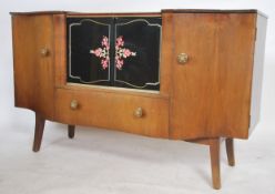 A 1950's retro walnut serpentine fronted cocktail