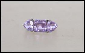 A hallmarked 9ct white gold ring set with purple s