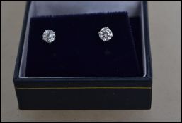 A pair of ladies 14ct white gold and diamond stud