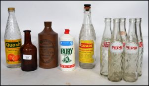 A collection of vintage advertising bottles to include; Bristol Burnishing Ink stone flagon, 5x
