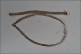 A sterling silver fancy link necklace and near matching bracelet of similar form with clip clasps.