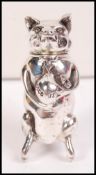 A silver gentleman's vesta case in the form of an upright seated pig having a hinged top head with