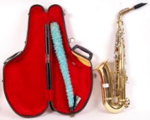 An Evette made brass saxophone. Presented within t