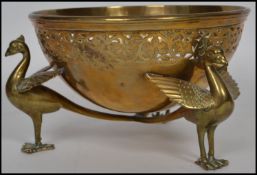A Turkish / Islamic 20th century unusual brass bowl raised on tripod bird legs with a fret pierced
