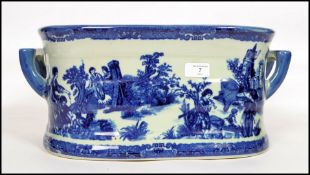 A large Victorian style blue and white willow patt
